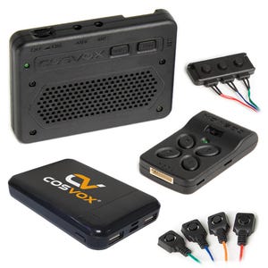 May include: A set of black electronic devices, including a speaker with the text "COSVOX", a power bank with the "COSVOX" logo, a remote control, and several wired buttons. The speaker has buttons labelled "ON/OFF", "AUX", "MIC", and "USB".