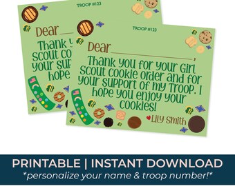 Può includere: Due biglietti di ringraziamento verdi delle Girl Scout con illustrazioni di biscotti. Le carte riportano il testo "Grazie per il tuo ordine di biscotti Girl Scout e per il tuo supporto al mio gruppo. Spero che ti piacciano i tuoi biscotti!" e "Gruppo #123".