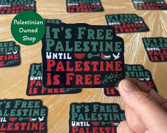 May include: A black and green sticker with the text "It's Free Palestine Until Palestine Is Free". The sticker features a watermelon, a key, a dove, and a Palestinian flag.