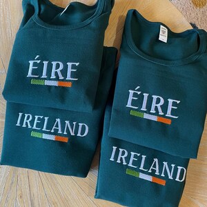 May include: Four green t-shirts with white embroidery. The shirts have the words "&Eacute;IRE" and "IRELAND" with a green, white, and orange stripe representing the Irish flag.