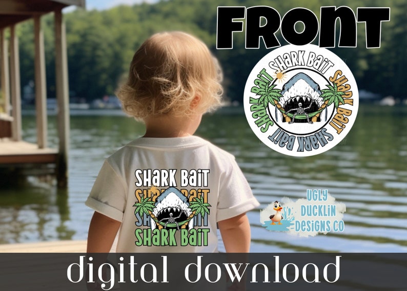 May include: A white t-shirt featuring a graphic of a shark with a skeleton in a hammock between palm trees. The text "Shark Bait" is repeated around the graphic. The shirt is being worn by a child standing in front of a lake.
