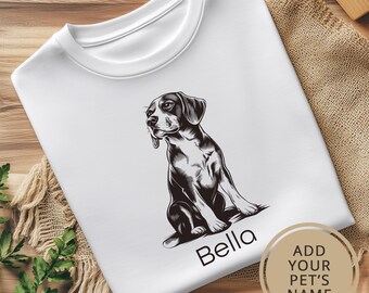 May include: White t-shirt with a black and white illustration of a beagle dog sitting. The dog's name, "Bella", is printed below the illustration.  Add your pet's name.