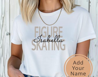 May include: White t-shirt with the text "FIGURE SKATING" in brown letters. The name "Isabella" is written in black cursive script between the words "FIGURE" and "SKATING".