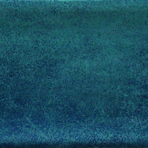 May include: A rectangular, teal-colored tile with a textured surface. The tile has a gradient effect, transitioning from a darker teal at the bottom to a lighter teal at the top. The right edge has a white, textured design.