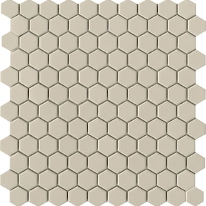 May include: A sheet of beige hexagon-shaped ceramic tiles. The tiles are arranged in a repeating pattern.