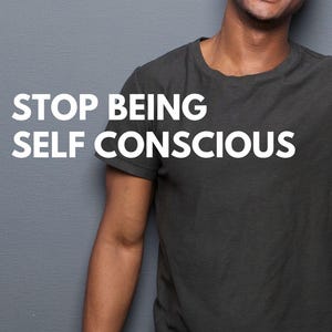 May include: A man wearing a dark gray t-shirt with the text "STOP BEING SELF CONSCIOUS" in white letters. The man is smiling and looking at the camera. The background is a light gray wall. The text "Mental Imagery Therapy" is at the top of the image. The text "Ermina Isanovic CBT, Hypnotherapist, Coach, BA Psychology" is at the bottom of the image.