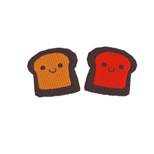 May include: Two embroidered bread slices with happy faces. One slice is orange and the other is red.