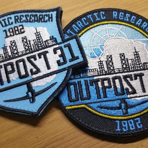 May include: Two blue and black embroidered patches with the text "Antarctic Research 1982" and "Outpost 31".