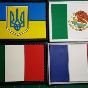 May include: Four embroidered patches featuring the flags of Ukraine, Mexico, Italy, and France. The patches are rectangular and have black stitching around the edges.