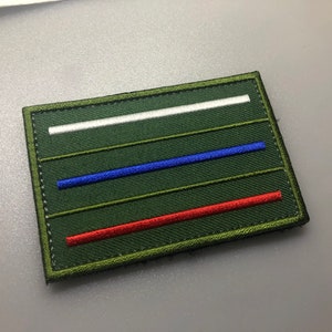 May include: A green embroidered patch with three horizontal stripes in white, blue, and red.