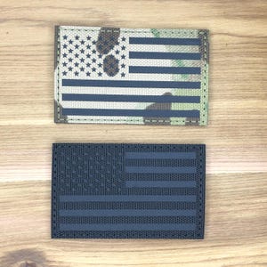 May include: Two rectangular patches with the American flag design. One has a camouflage background with a blue and white flag design. The other is navy blue with a navy blue flag design.