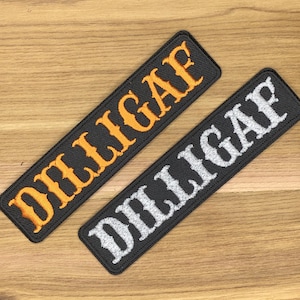 May include: Two rectangular embroidered patches with the word "DILLIGAF". One patch features orange lettering, the other has white lettering. Both patches are on a black background.