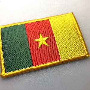 May include: A yellow, red, and green embroidered patch with a yellow star in the center. The patch is surrounded by a yellow border.