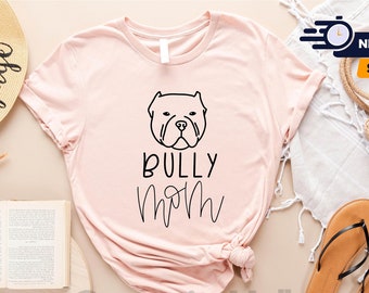 May include: A pink t-shirt with a black outline of a bulldog's head and the text "Bully Mom" in black.