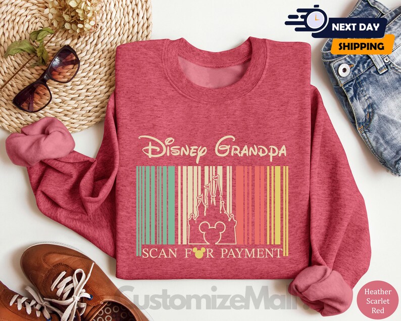 a pink sweatshirt with a Disney Grandpa design, a pair of brown shoes, sunglasses, and a woven basket.