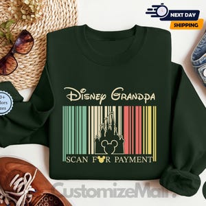 a green sweatshirt with a Disney Grandpa design, a pair of brown shoes, sunglasses, and a woven basket.