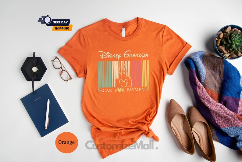 a collection of items, including a t-shirt with a Disney Grandda design, a pair of shoes, a notebook, a pen, a watch, a potted plant, and a scarf. The items are arranged on a white background, creating a visually appealing and organized display.