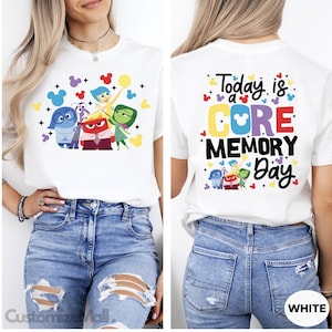 May include: White t-shirt with a graphic of the characters from the movie Inside Out, including Joy, Sadness, Anger, Disgust, and Fear. The back of the shirt says "Today is a CORE MEMORY Day" with a Mickey Mouse head in the word "CORE".