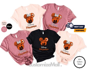 May include: A collection of t-shirts in various colors, including black, peach, and mauve. Each shirt features a Halloween-themed graphic with a Mickey Mouse silhouette, bats, and the text "Disney Halloween."
