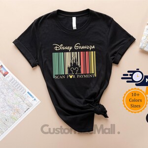 a black t-shirt with a Disney Grandpa theme, along with a map and some shipping labels.