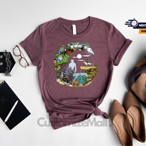 a purple t-shirt with a colorful graphic design, a pair of brown shoes, a black notebook, a pair of glasses, a bouquet of white flowers, and a black pen.