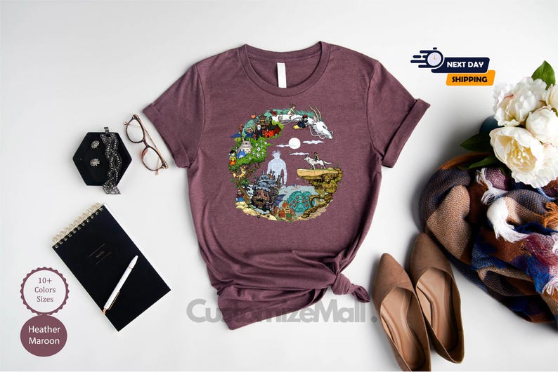 a purple t-shirt with a colorful graphic design, a pair of brown shoes, a black notebook, a pair of glasses, a bouquet of white flowers, and a black pen.