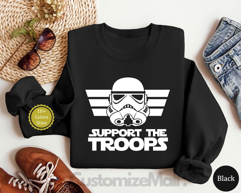 May include: Black sweatshirt with a white graphic of a Star Wars Stormtrooper helmet with the text "Support the Troops".