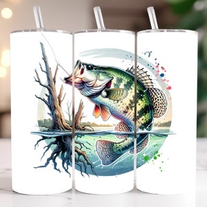 May include: Three white tumblers with a colorful design of a fish jumping out of the water. The fish is green, brown, and white with a splash of color behind it. The design is surrounded by a circle with a blue, green, and white background.