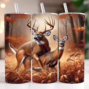 May include: A sublimation design featuring a pair of white-tailed deer in a forest setting. The deer are standing in tall grass and leaves, with a blurred background of trees. The design is perfect for creating custom tumblers, mugs, or other personalized items.