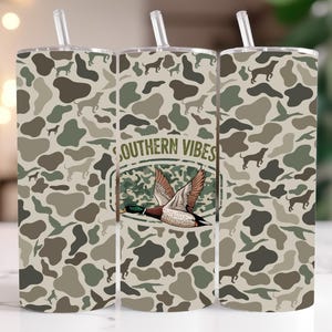 May include: Three 20 oz. tumbler designs with a camouflage pattern. The center tumbler features a duck with the text "Southern Vibes".