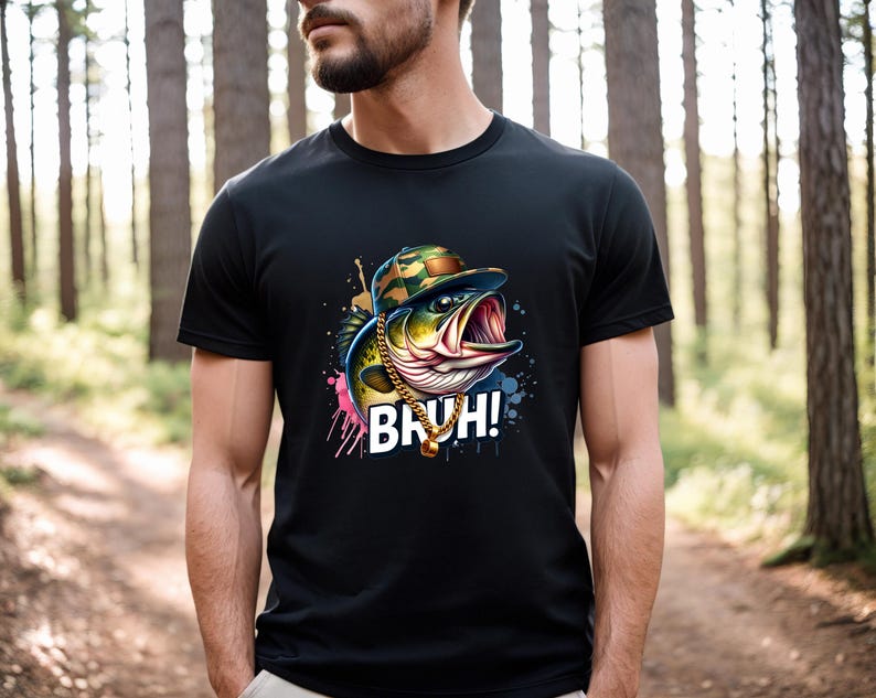 May include: Black t-shirt featuring a cartoon fish wearing a camouflage hat and gold chain. The fish has an open mouth and the word "BRUH!" is printed in white. The design includes colorful paint splatters.