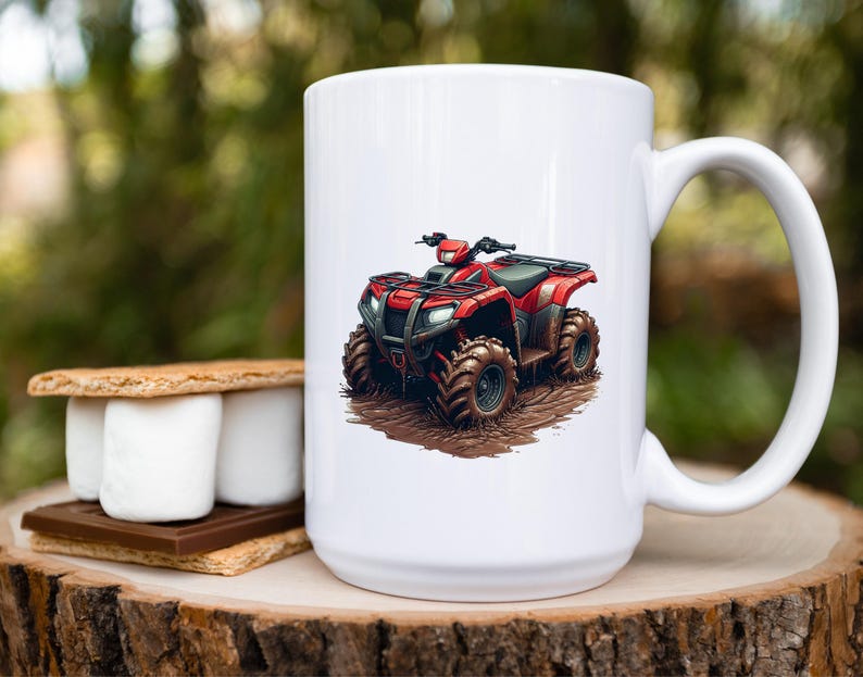 May include: White ceramic mug featuring a red ATV graphic. The ATV is detailed with black accents and sits on a muddy ground illustration. The mug has a large handle and is set on a wooden surface.