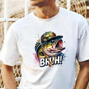 May include: White t-shirt featuring a cartoon bass wearing a camouflage cap and gold chain. The fish has an open mouth and the word "BRUH!" in a bold font. Colorful paint splatters surround the fish.