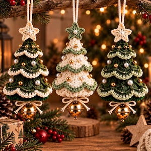 May include: Three hanging Christmas tree ornaments crafted from crochet yarn. Two trees are dark green with cream-colored scalloped edges, and one central tree is cream with green edges. Each features gold beads, white pearls, and a gold jingle bell.