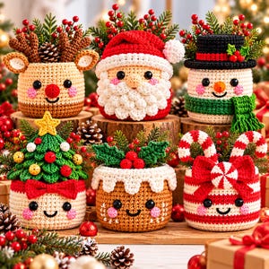 May include: Six crocheted Christmas-themed containers featuring a reindeer, Santa Claus, a snowman, a decorated tree, a pudding, and a candy cane design. Each container has a smiling face, rosy cheeks, and is filled with pine sprigs and red berries.