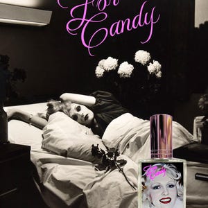 May include: A perfume bottle with a pink and gold cap and a label featuring a woman's portrait and the text "For Candy" and "Always be Yourself." The background is a black and white photo of a woman lying on a bed.