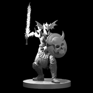 May include: A white painted miniature figurine of a warrior with a skull-shaped shield and a sword. The warrior is wearing armor and a helmet with horns.