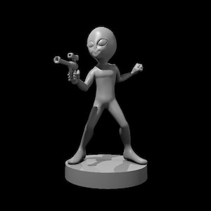 May include: A gray alien figurine holding a toy gun, standing on a round base.