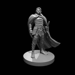 May include: A gray painted miniature figurine of a person wearing armor and a cloak, holding a sword. The figurine is standing on a round base.