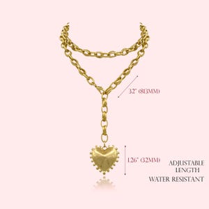 May include: Gold-toned necklace with a heart pendant. The necklace is 32 inches (813mm) long and features an adjustable length. The heart pendant is 1.26 inches (32mm) in length. The necklace is water resistant.