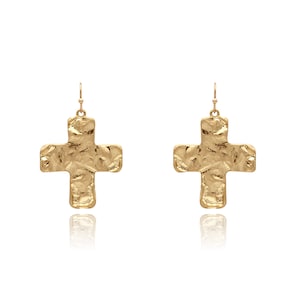 May include: A pair of gold-tone cross-shaped dangle earrings. The crosses have a textured, hammered finish.
