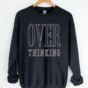 May include: Black sweatshirt with white text that reads "OVER THINKING".
