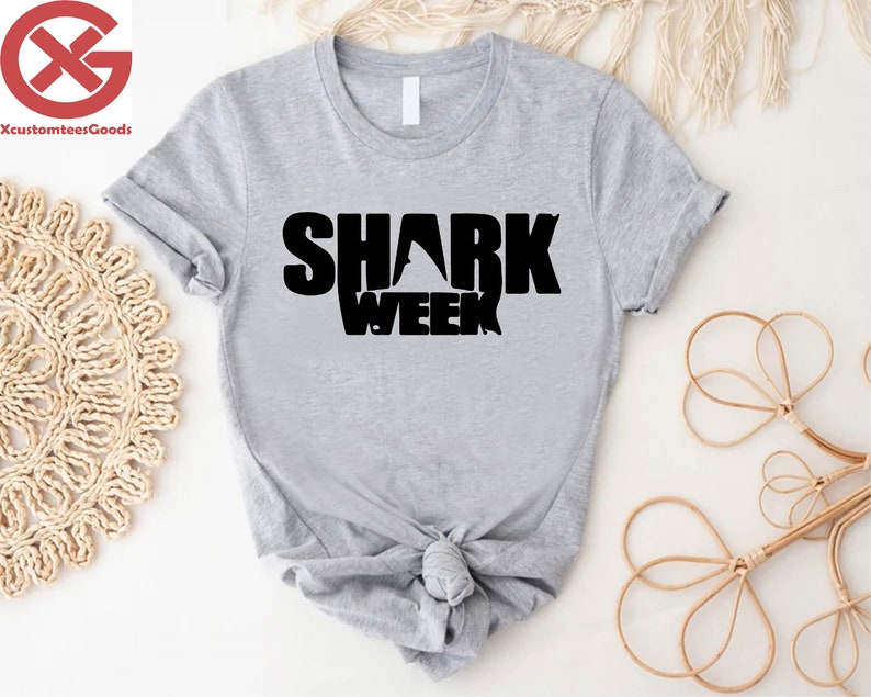 a t - shirt with the words shark week on it