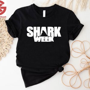 a black shirt with the words shark week printed on it