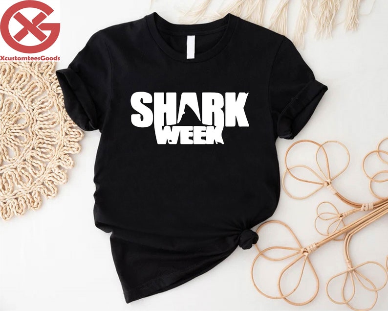 a black shirt with the words shark week printed on it