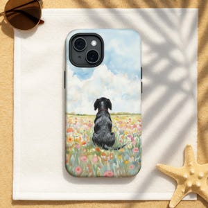 May include: A phone case featuring a watercolor painting of a black dog sitting in a field of colorful flowers, with a blue sky and clouds in the background. The case has a black camera housing and black side buttons.
