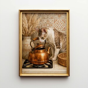 May include: A framed image features a copper tea kettle on a stovetop, with a cat curiously observing it. A vase with dried plants and a woven basket are also present. The background has patterned tiles, and the frame is gold.
