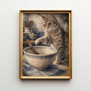 May include: A framed print featuring a tabby cat reaching into a ceramic bowl with a wooden spoon. The bowl sits on a blue and white patterned cloth. The background includes kitchen elements like utensils and ceramic containers.