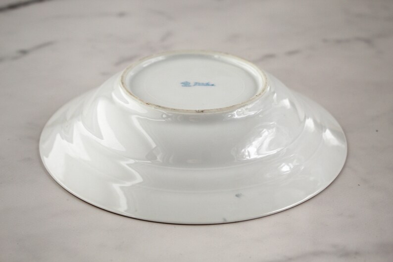 Bottom of pink flowered butter dish
