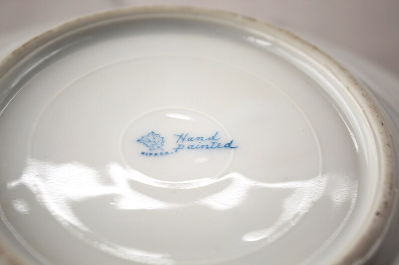 Nippon mark on bottom of pink flowered butter dish